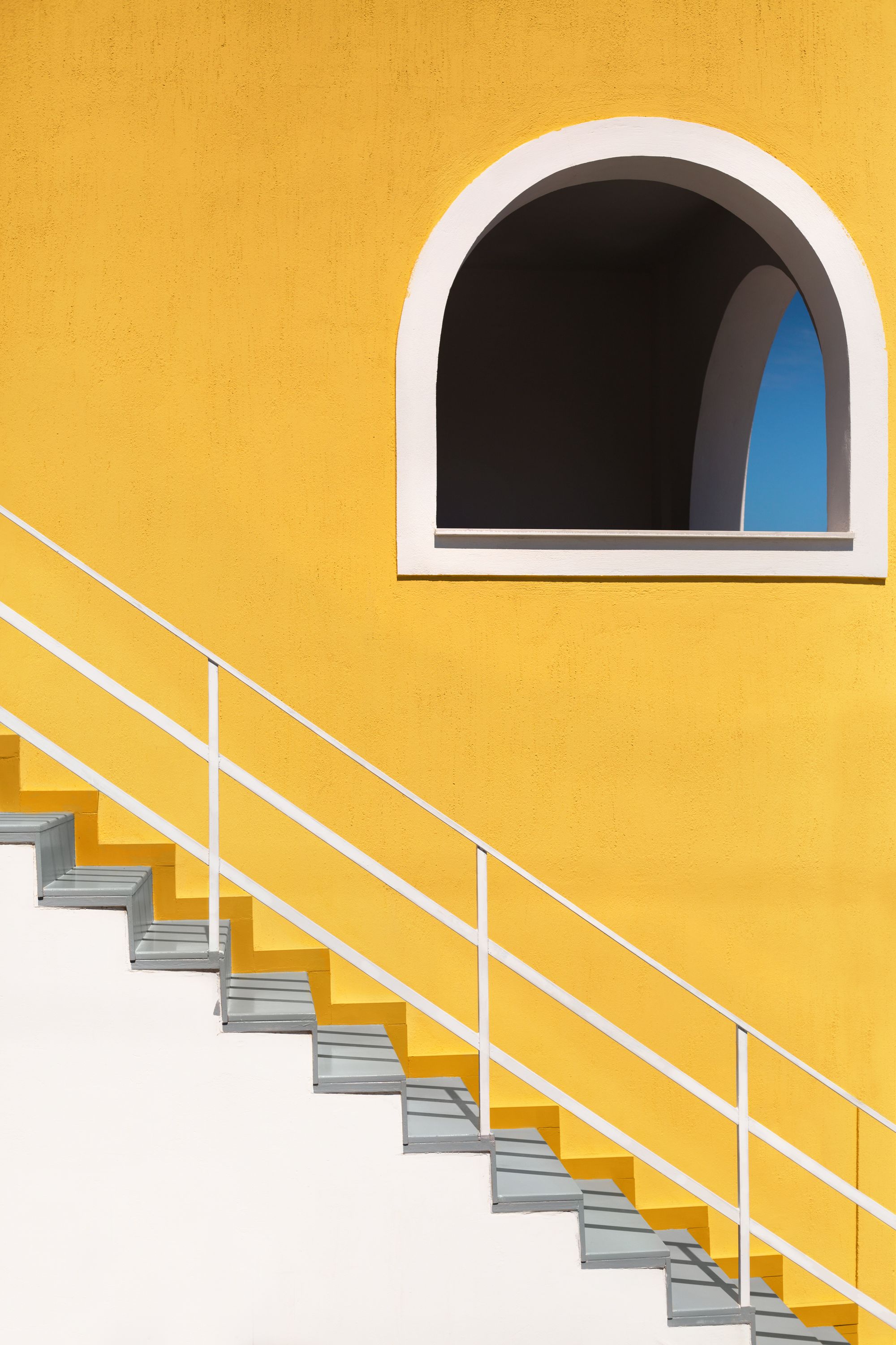 White staircase against a yellow wall